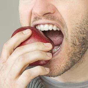 man eating apple